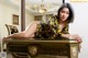 A woman laying on top of a desk in a room.